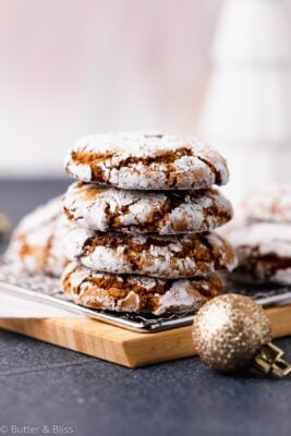 Stack of molasses crinkle cookies on a wood serving tray