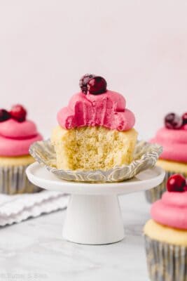 Single small batch vanilla cupcake with a bite