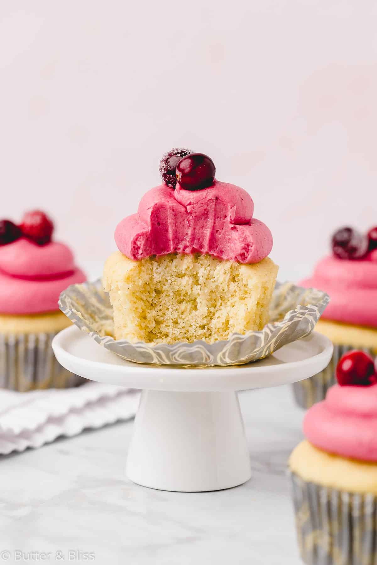 Single small batch vanilla cupcake with a bite makes a delicious spring dessert