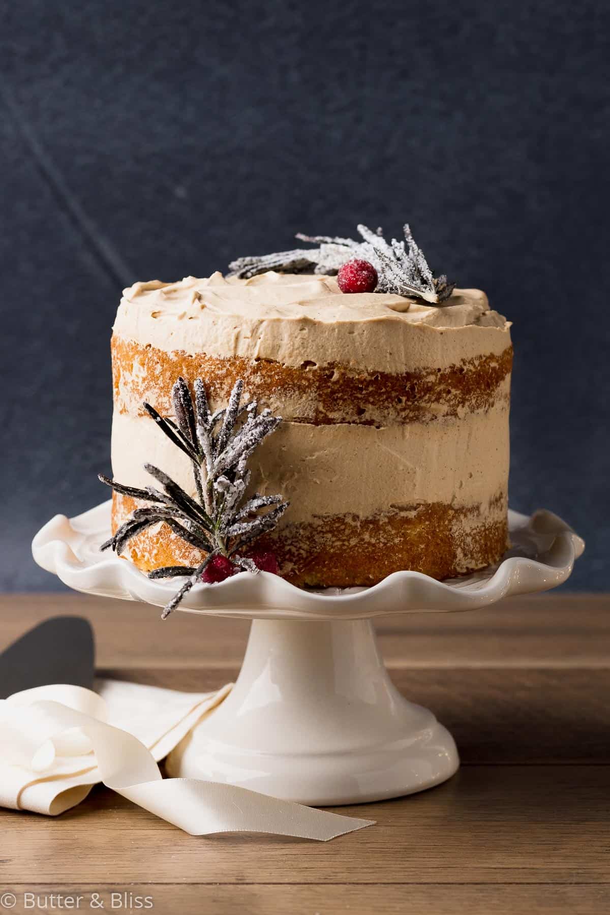 Vanilla orange gingerbread cream cake on a cake stand