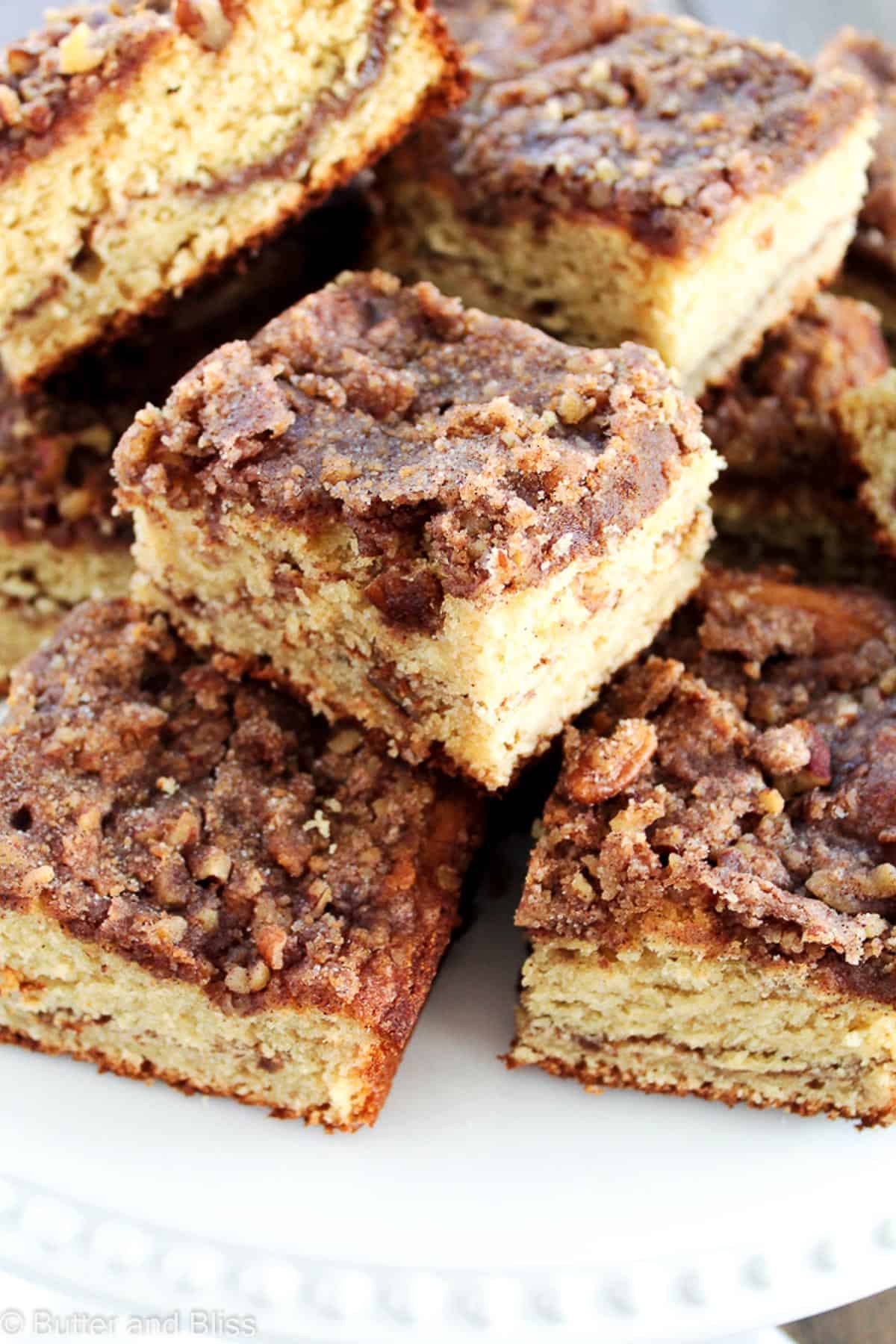 A plate of applesauce coffee cake squares set on a table.