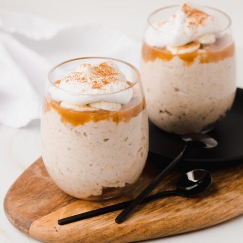 Caramel banana overnight oats in glasses on a small platter