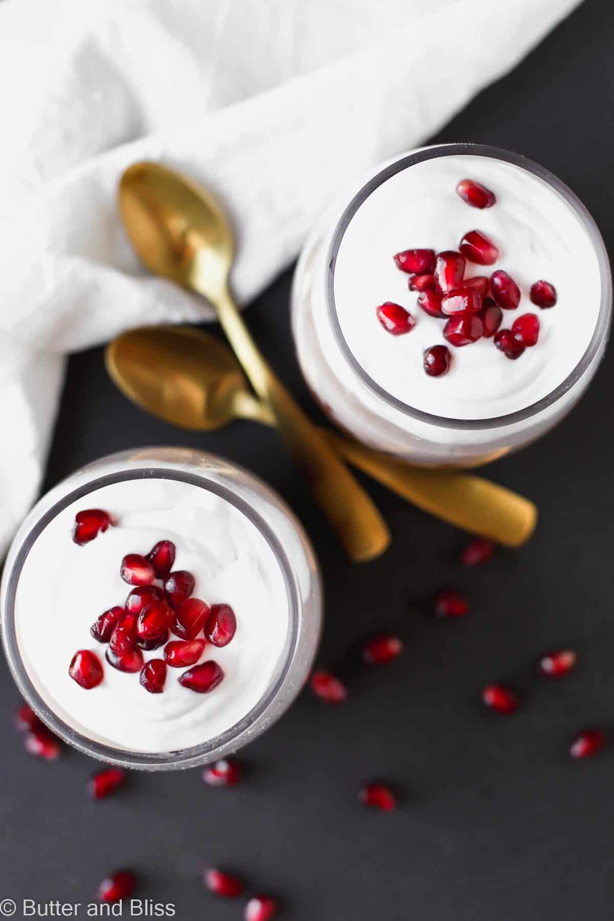Top view of chia pudding with pomegranate seeds and whipped cream