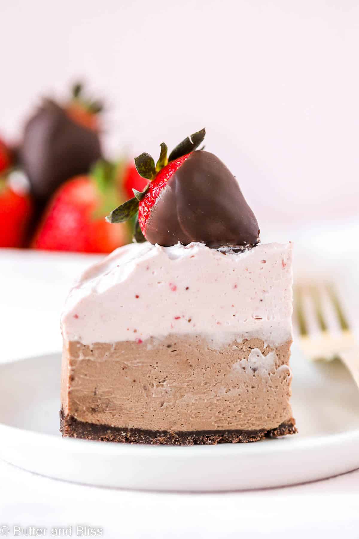 Slice of chocolate strawberry mousse cheesecake on a plate for Valentine's Day.
