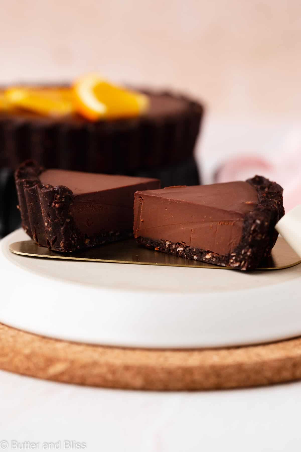 Small slices of chocolate orange gluten free tart on a cake server