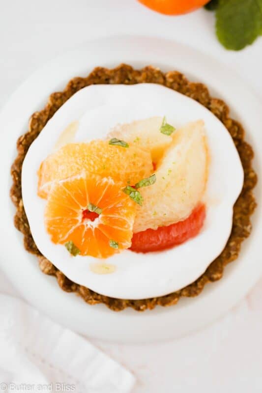 Top of a mini tart with cream and winter citrus