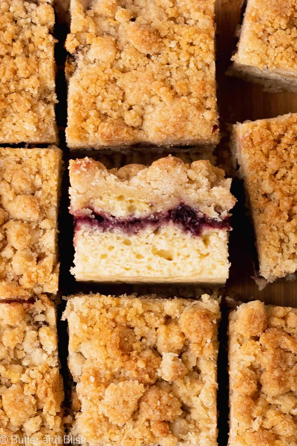 The layered inside of a bakewell crumb cake slice snuggled next to other cake slices.