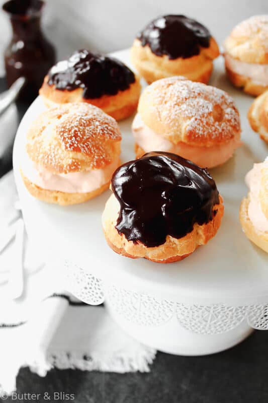 Fresh cream puffs with filling on a cake stand