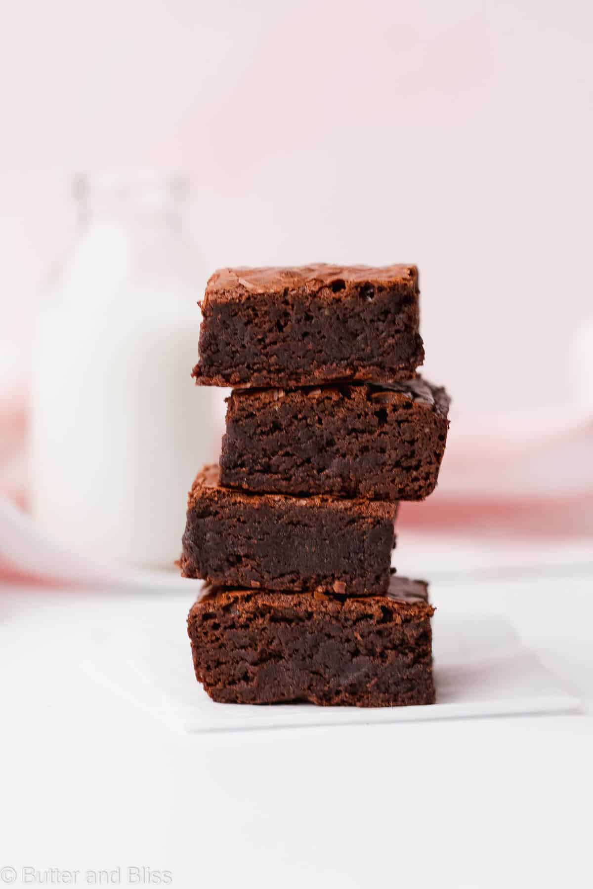 Stack of fudgy gluten free brownies on a table