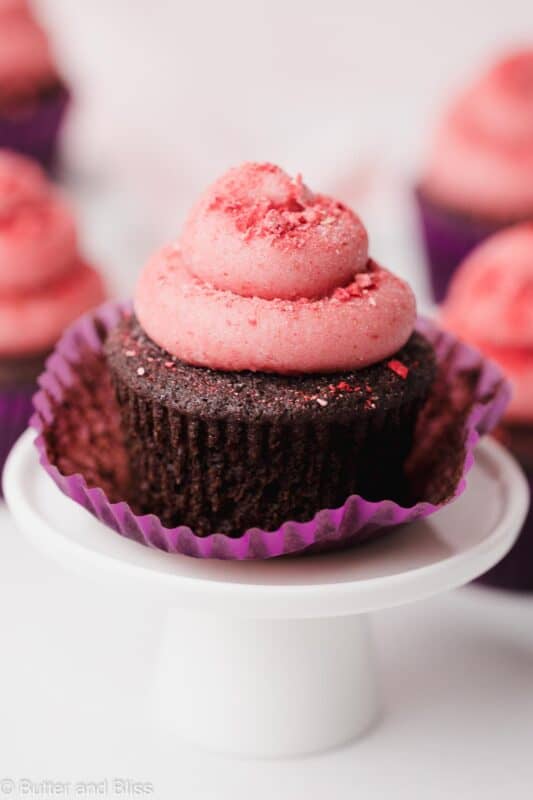 Frosted chocolate gluten free cupcake on a mini cake stand