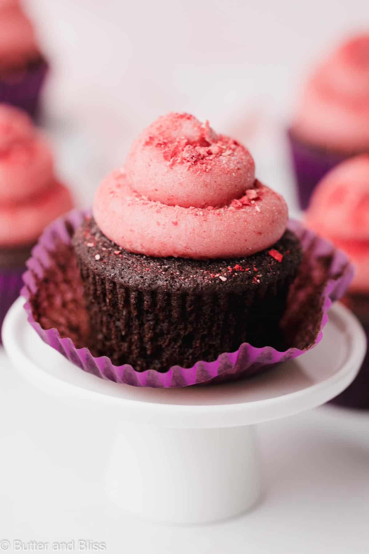 Frosted chocolate gluten free cupcake on a mini cake stand