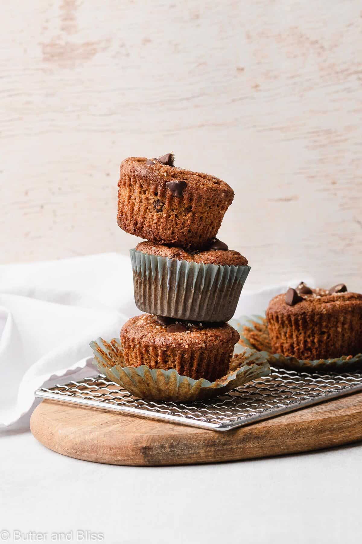 Gluten free chocolate chip muffins stacked on a wire rack