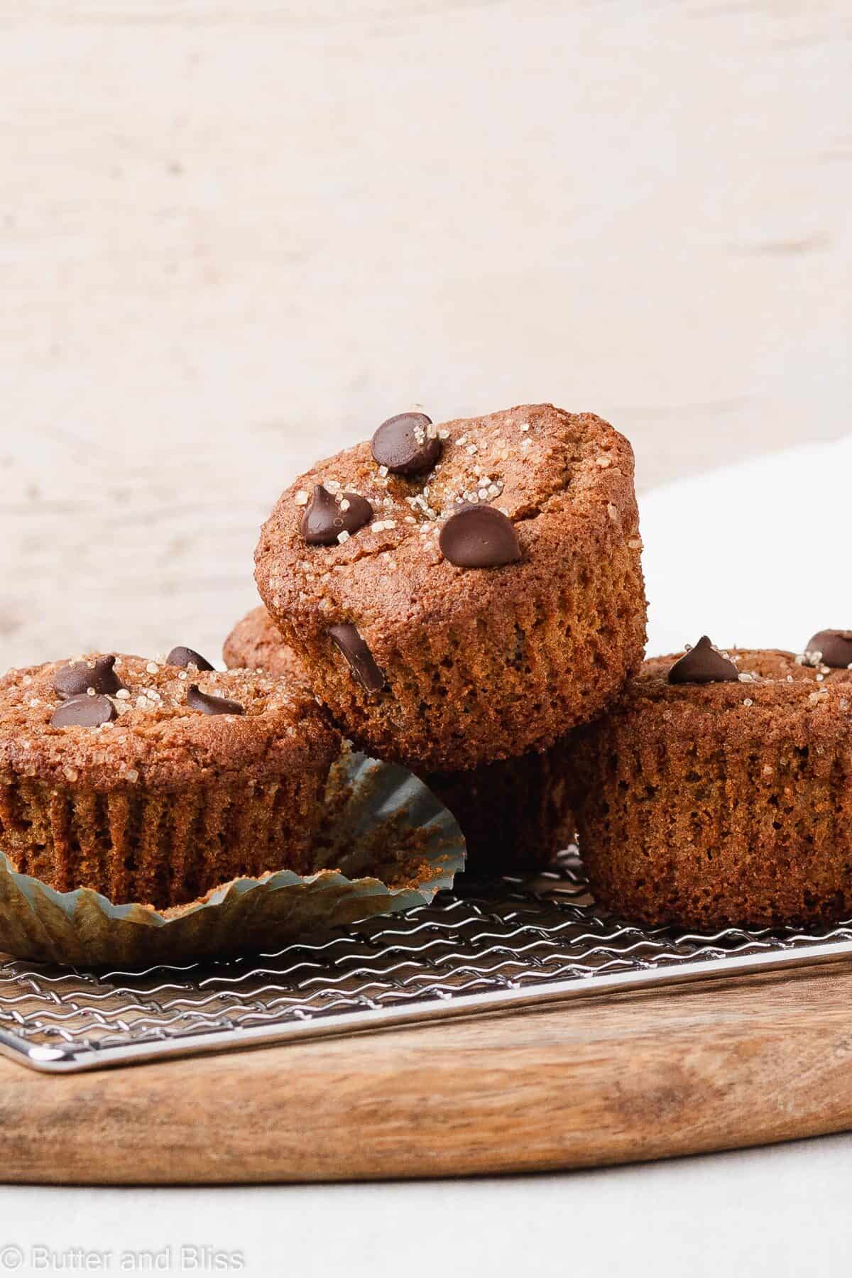 Gluten free chocolate chip muffins stacked on a wire rack
