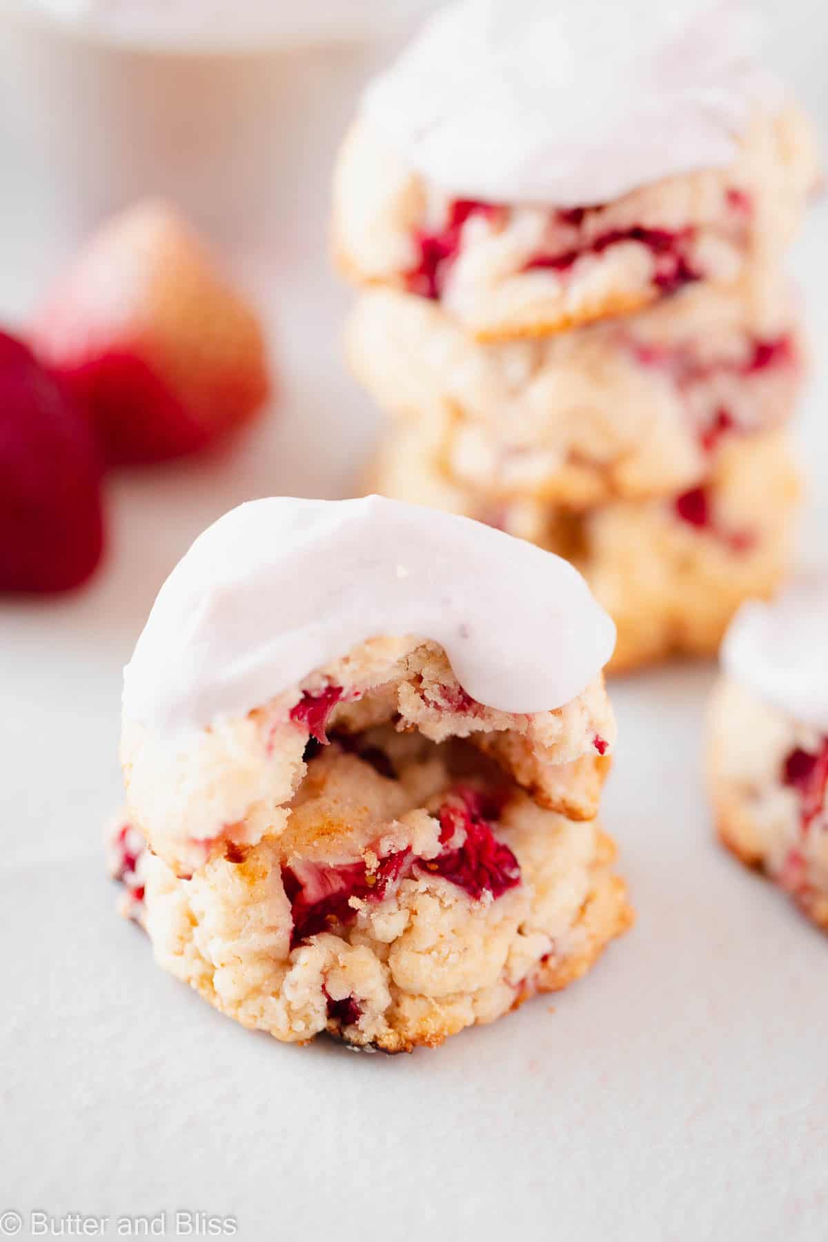 Close up of two strawberry shortcake biscuit cookies stacked on top of eachother