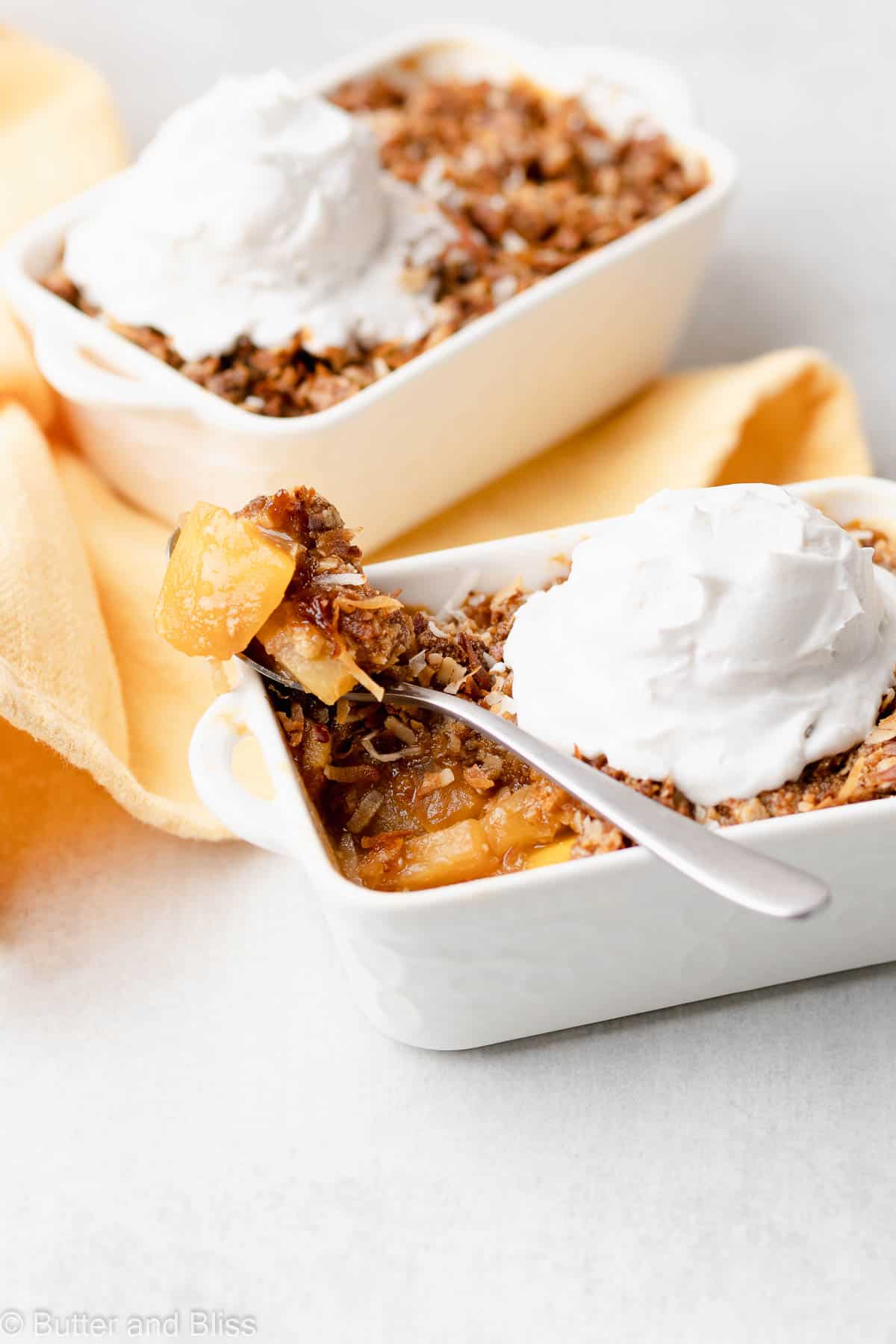 Pineapple mango crisp for one with whipped cream on top