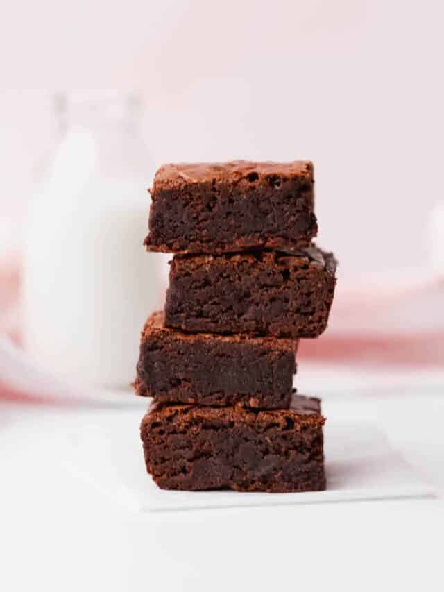 Stack of fudgy gluten free brownies on a table