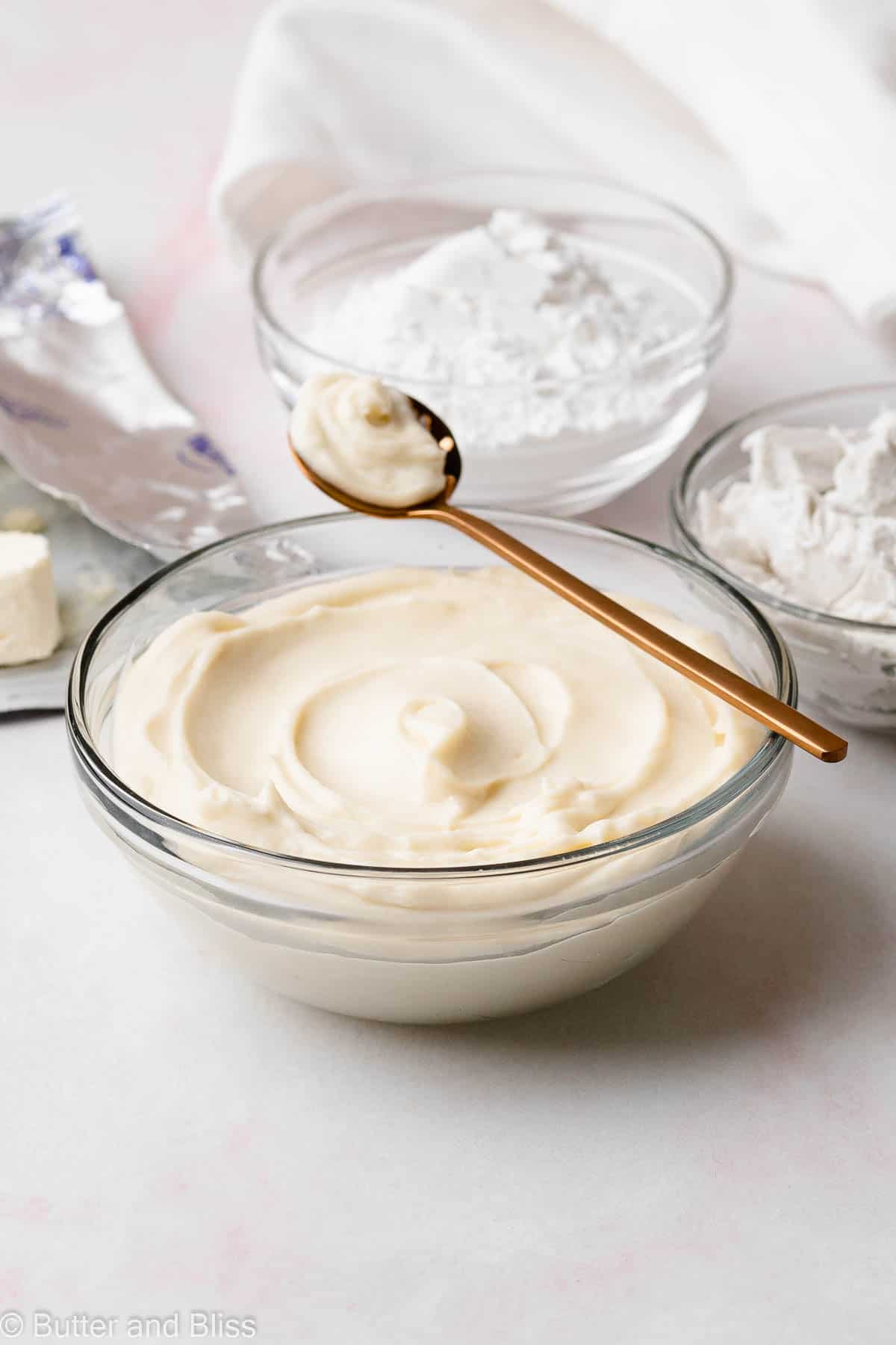 Bowl of cream cheese frosting on a table