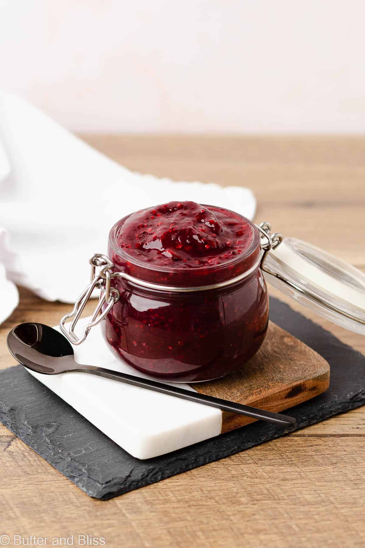 Chia raspberry jam in a small jar on a table