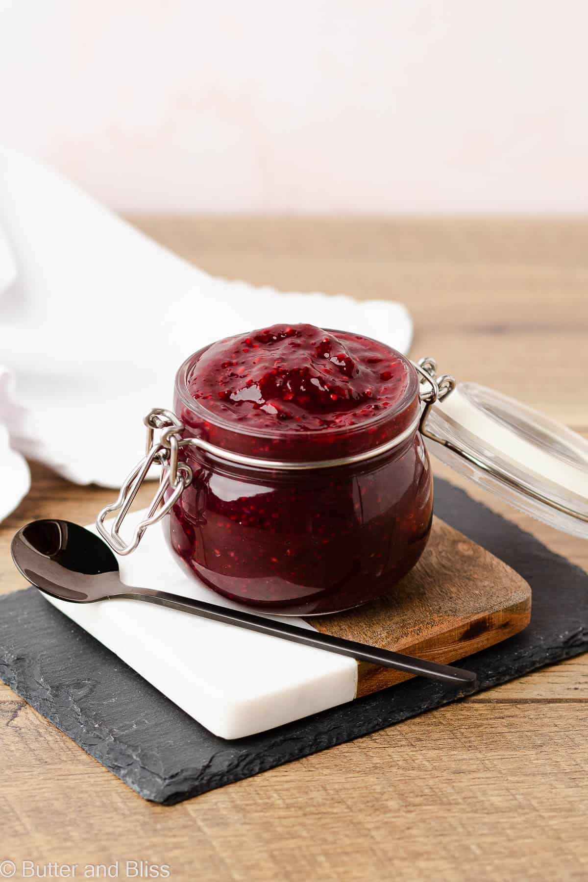 Chia raspberry jam in a small jar on a table