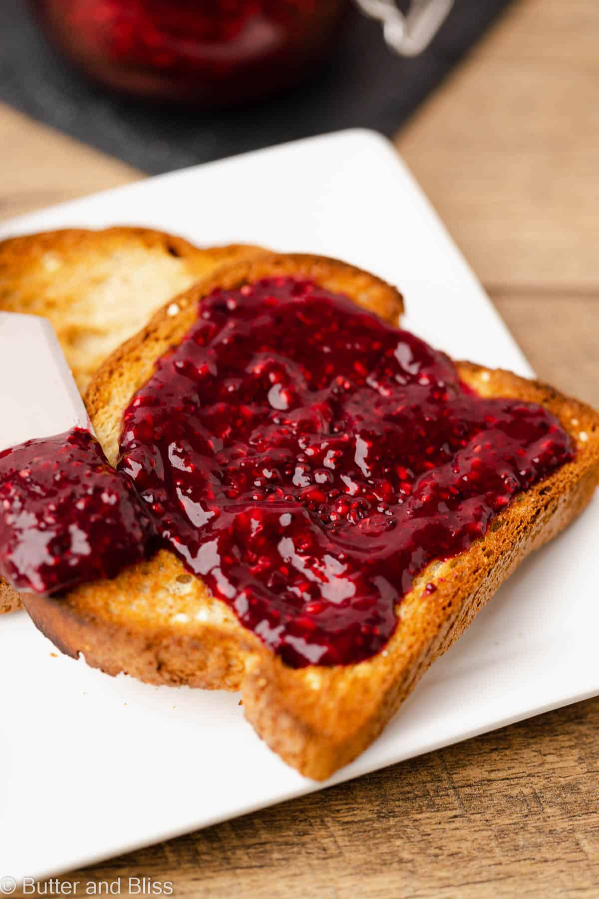 Raspberry chia jam spread on a piece of toast