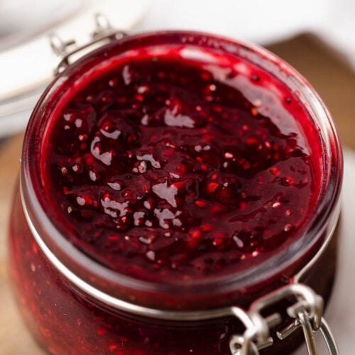 Close up of red raspberry chia jam in a jar