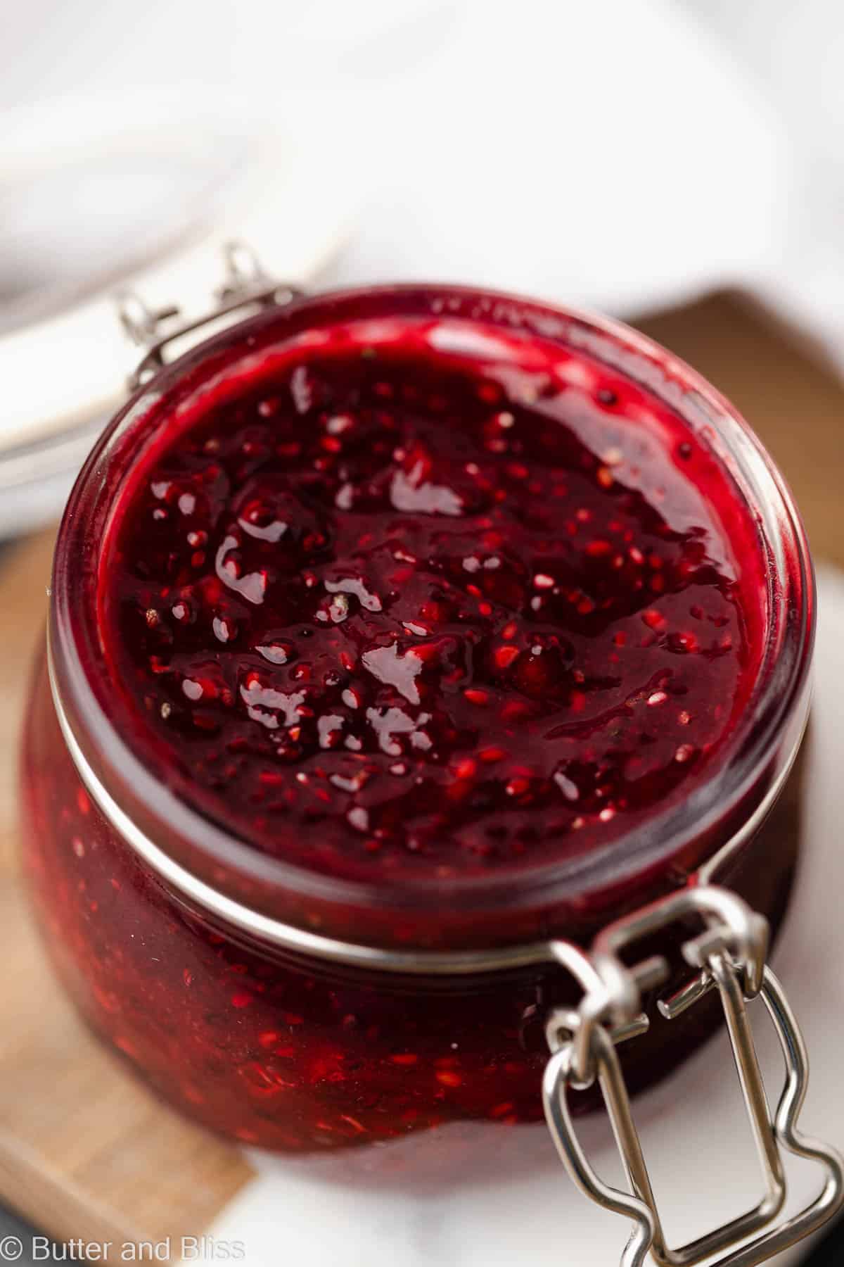 Close up of red raspberry chia jam in a jar