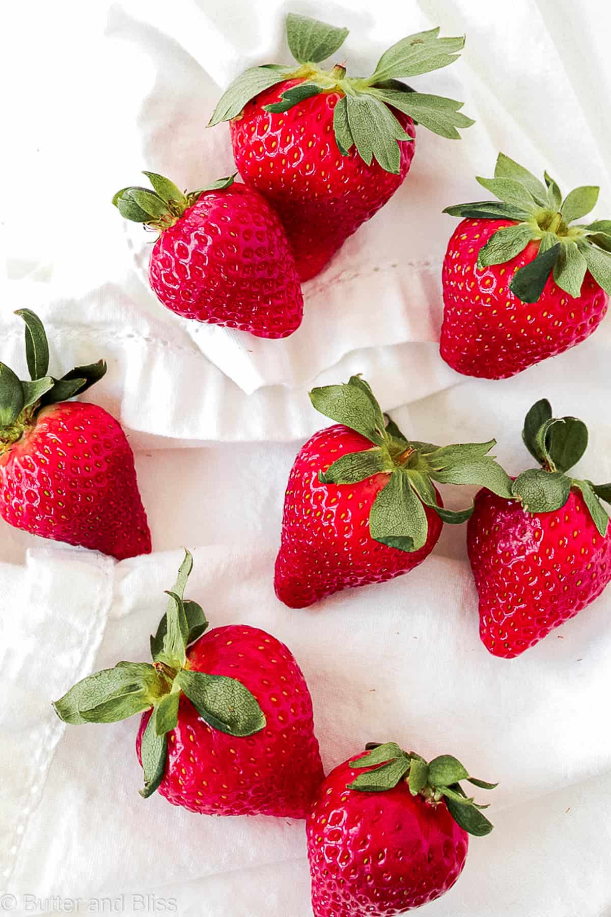 Fresh strawberries arranged on a white napkin