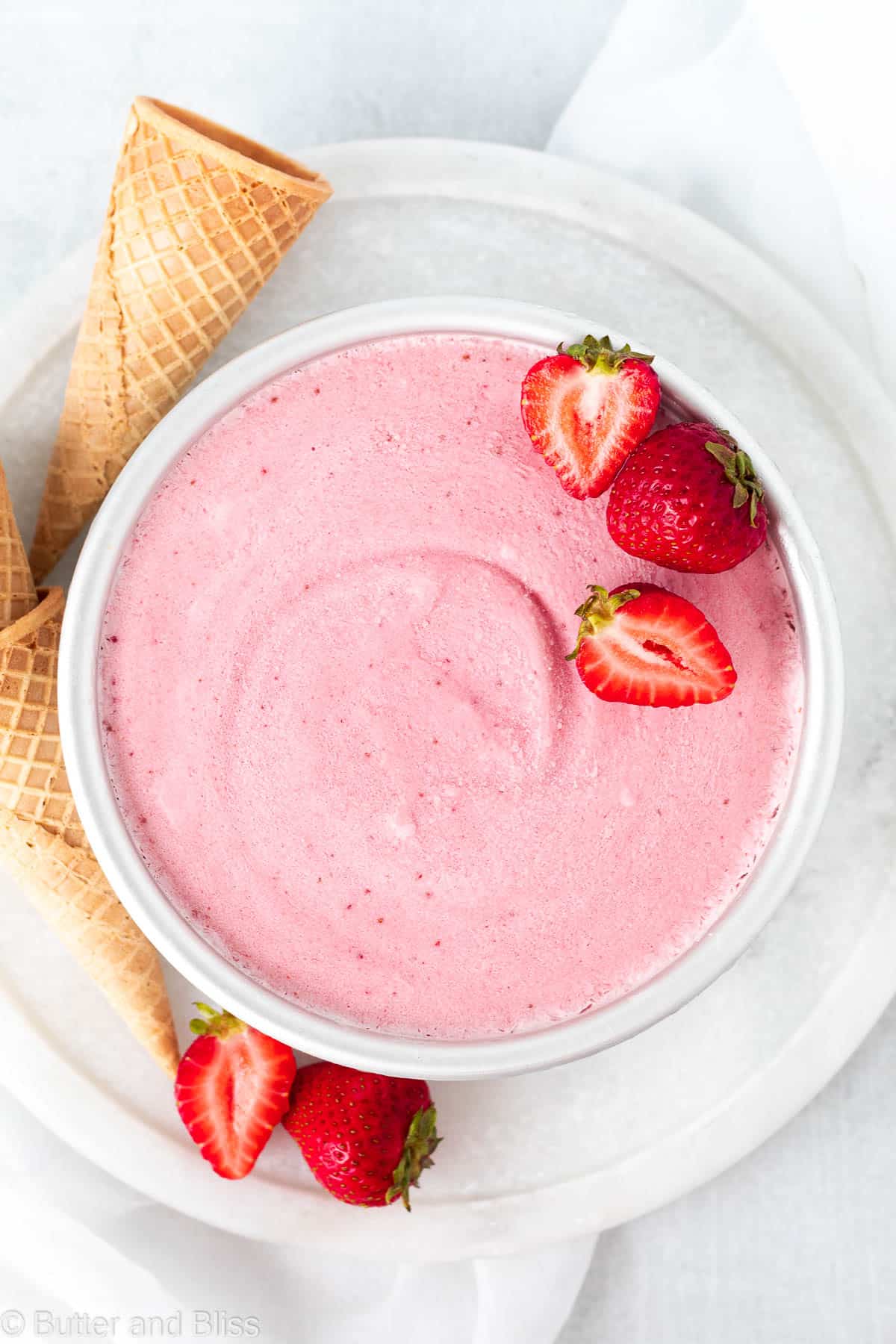 Dairy free strawberry ice cream in a round cake pan