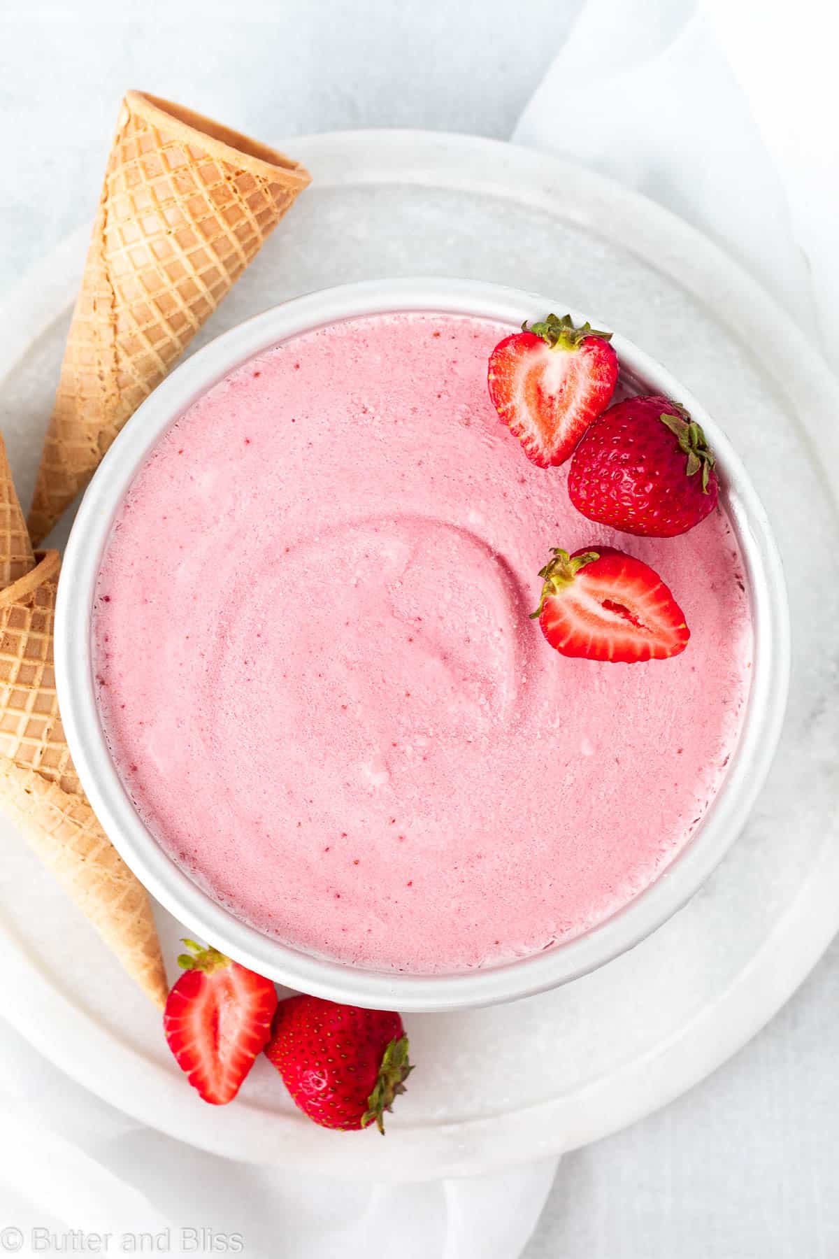 Dairy free strawberry ice cream in a round cake pan.