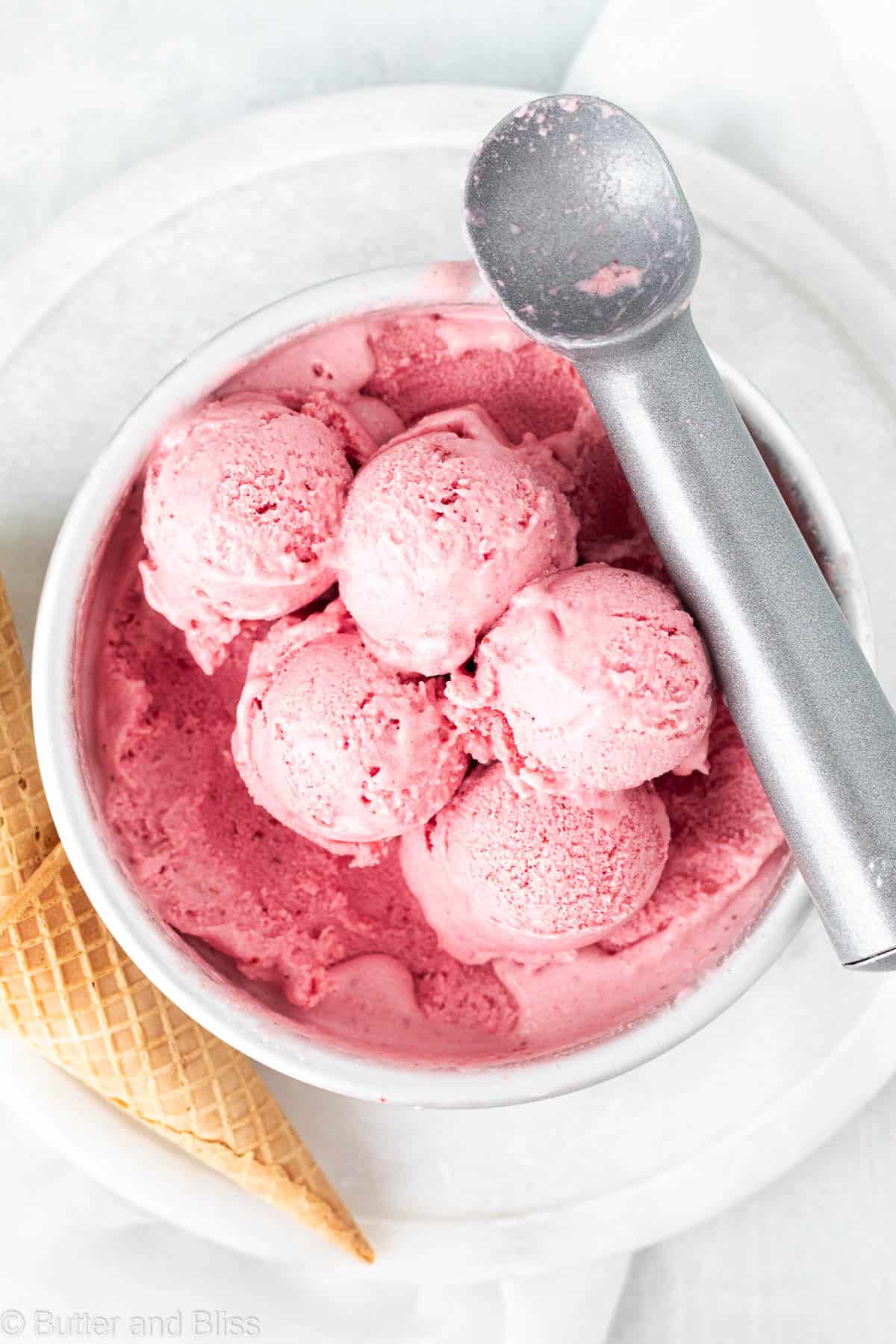 Scoops of strawberry dairy free ice cream in a round cake pan