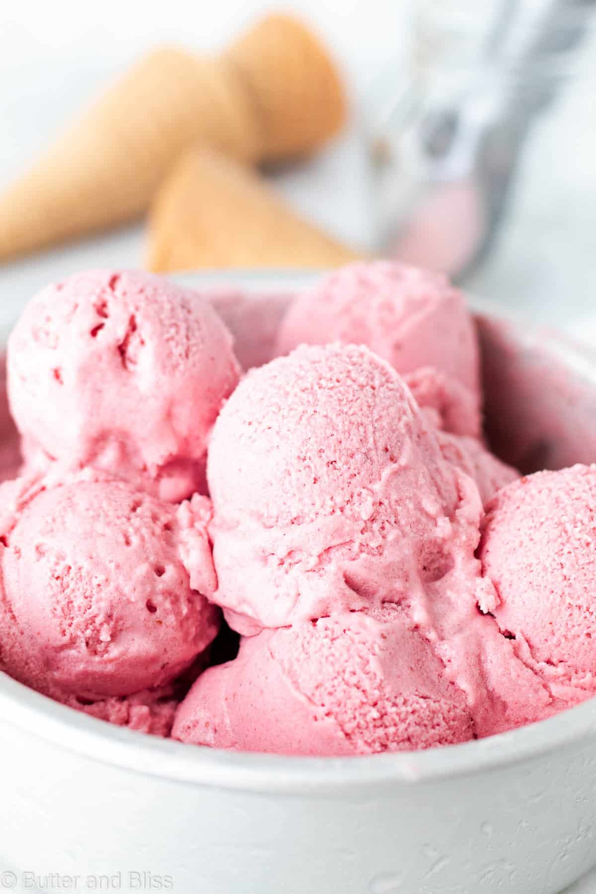 Close up of scoops of dairy free strawberry ice cream in a cake pan