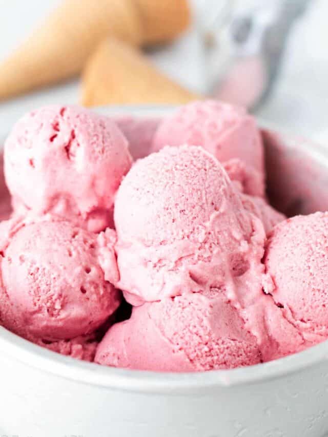 Close up of scoops of dairy free strawberry ice cream in a cake pan