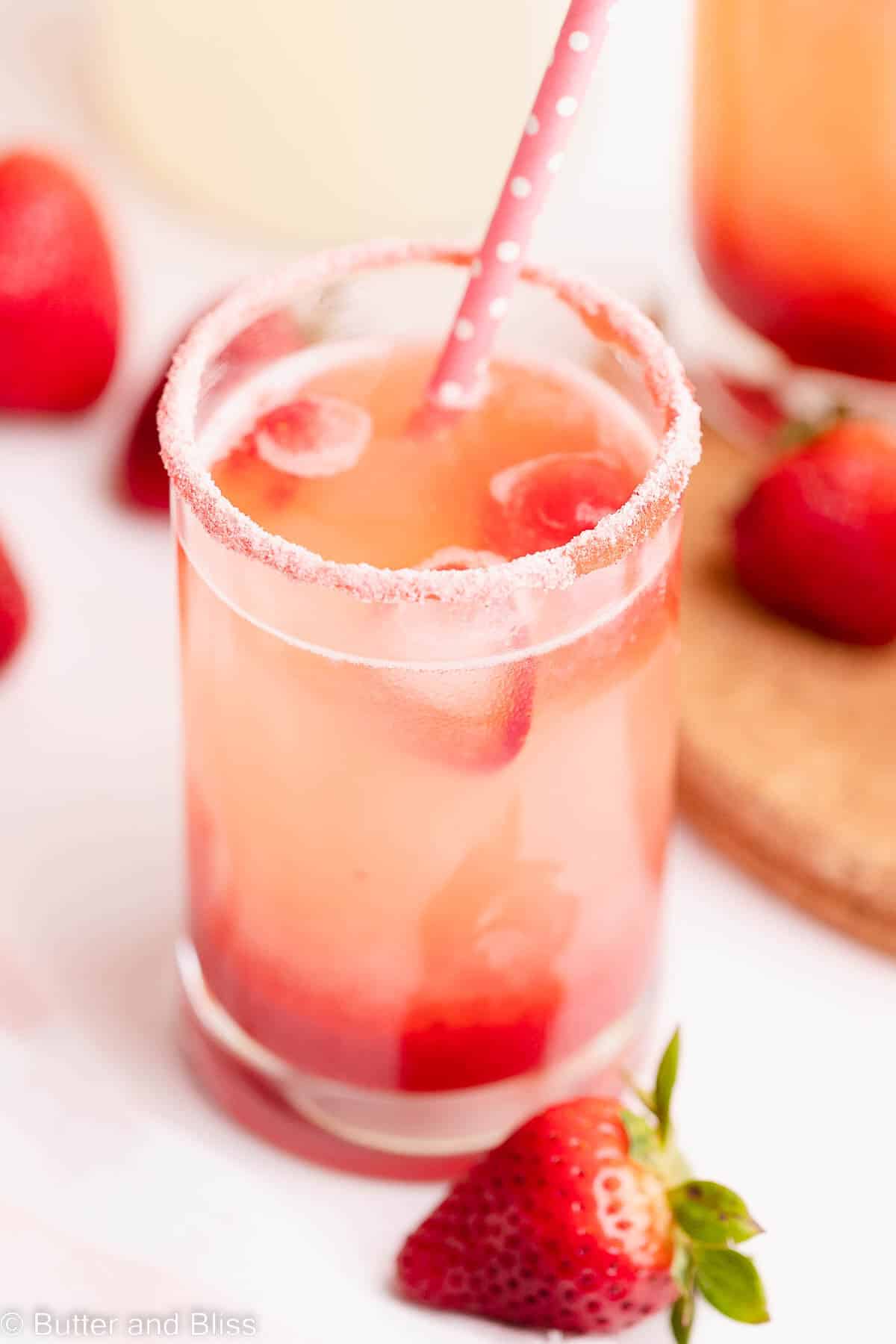 Close up inside a glass of strawberry lemonade with strawberry sugar rim