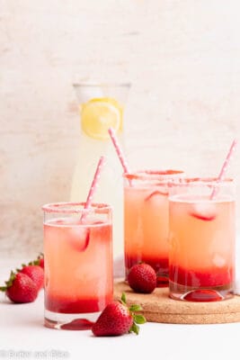 A tray of strawberry lemonade in small glasses