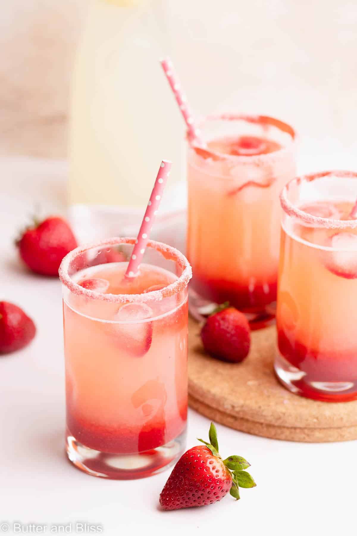 Strawberry lemonade in a small glass with strawberry sugar rim