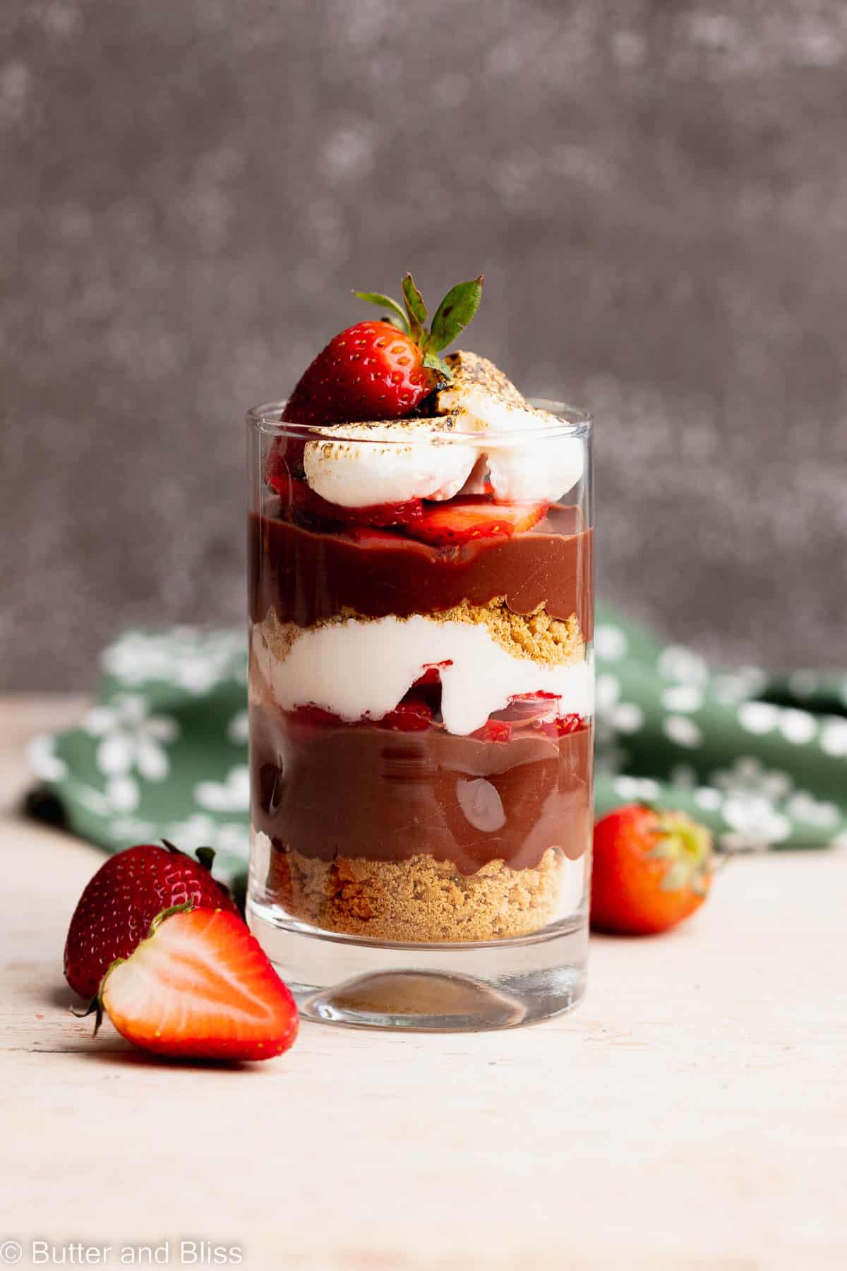 Single serving of gluten free strawberry smores parfait in a serving glass