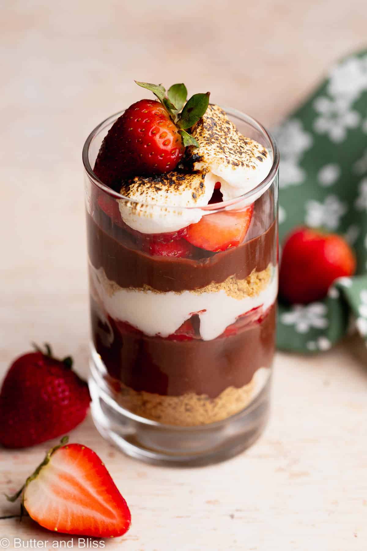 Gluten free strawberry s'mores parfait in a glass on a table