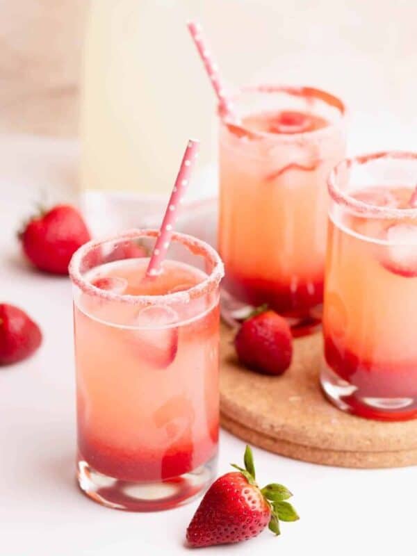 Strawberry lemonade in a small glass with strawberry sugar rim