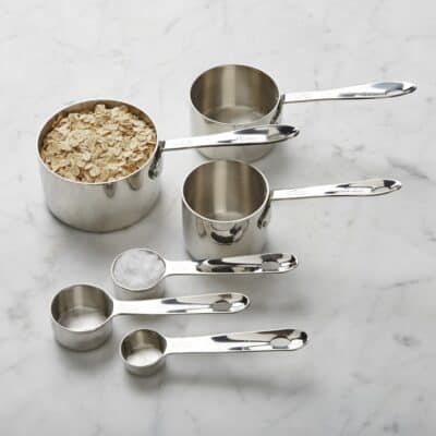 Variety of stainless steel measuring cups and spoons for small batch baking.