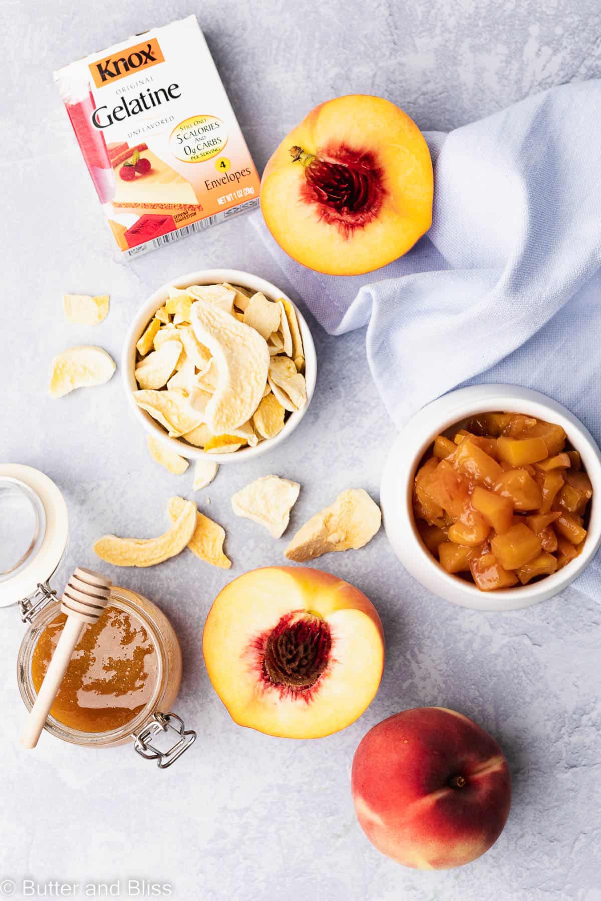 Peach panna cotta ingredients arranged on a light blue table