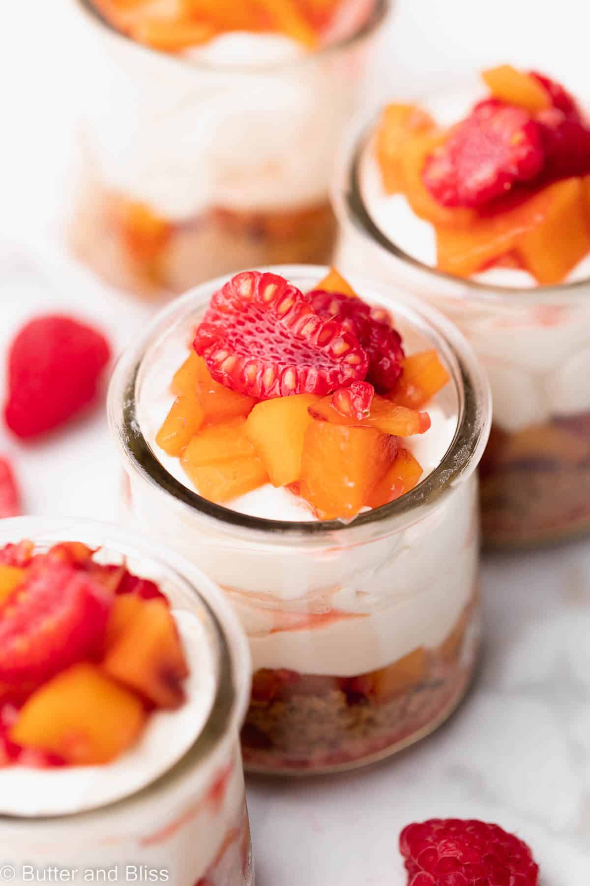 Single serving close up of a raspberry peach cheesecake cup