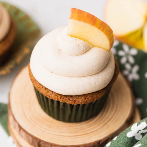Creamy caramel frosting made without butter piped onto an apple cupcake.