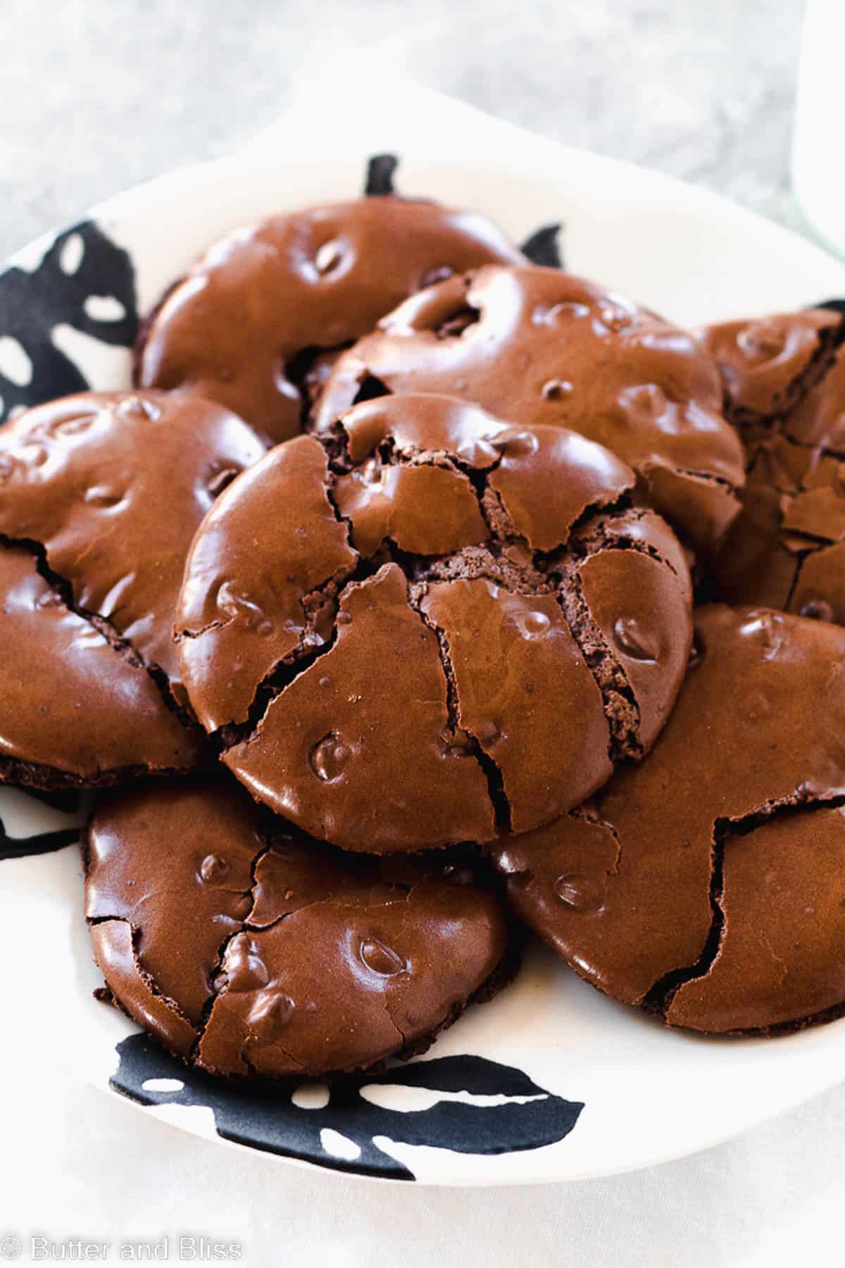Flourless chocolate cookies stacked on a plate.