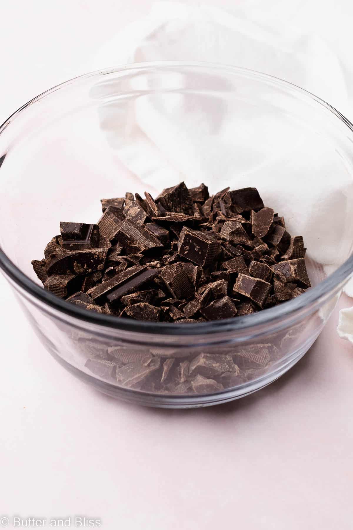 A bowl of chopped chocolate pieces.