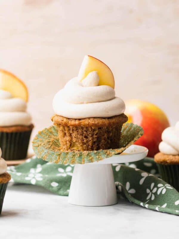 A single apple spice gluten free cupcake with the cupcake liner removed on a small cupcake stand.