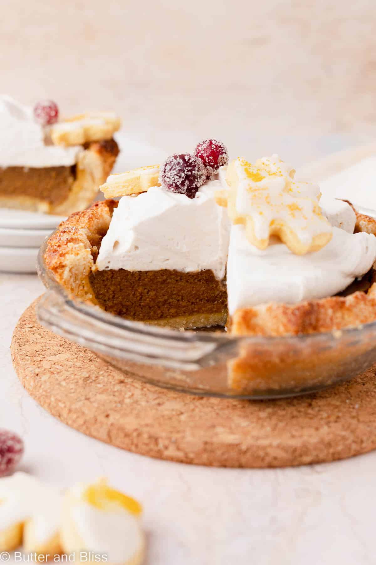 Thanksgiving day pie that has been sliced and sitting in a small glass pie dish.