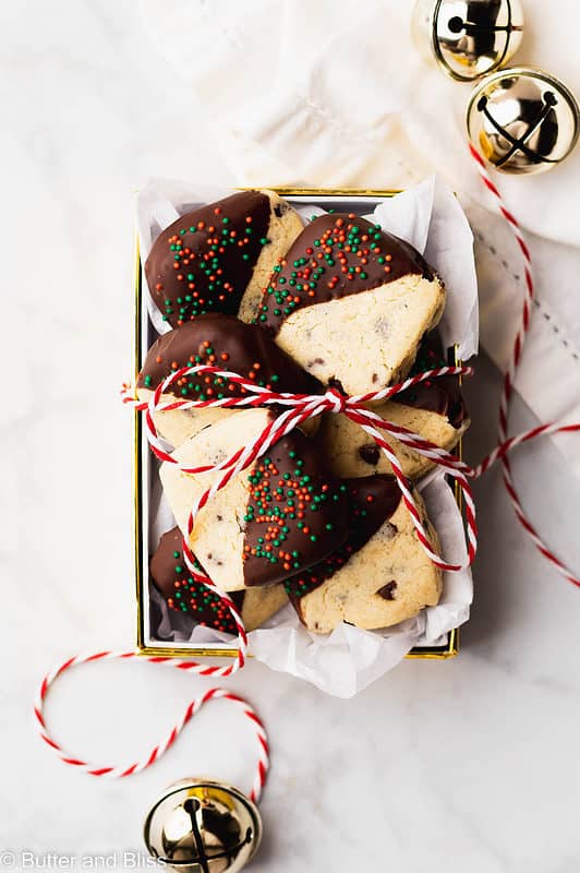 A small gift box full of chocolate dipped Christmas cookies.