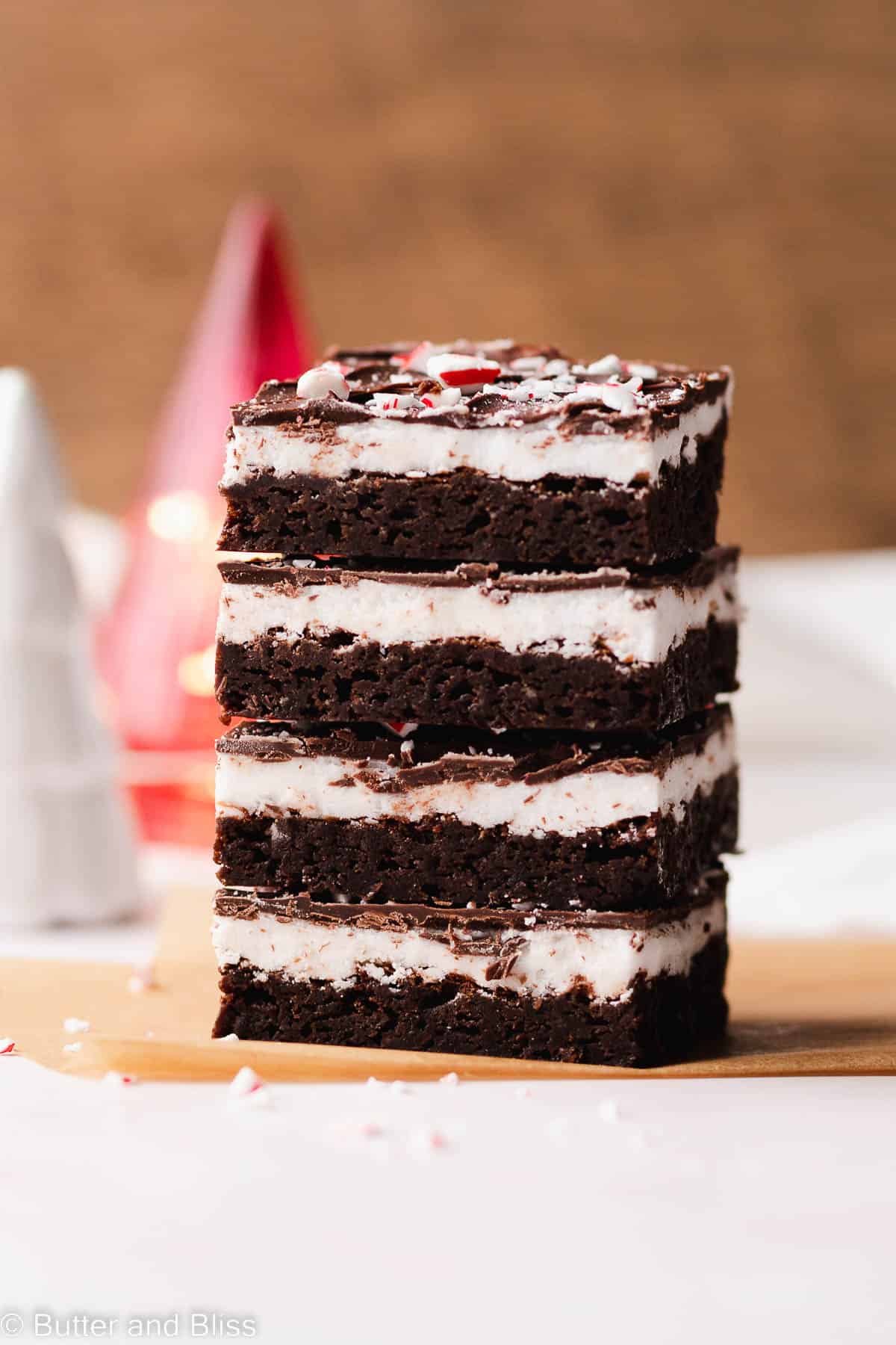 A pretty stack of peppermint patty gluten free brownies set on a table.