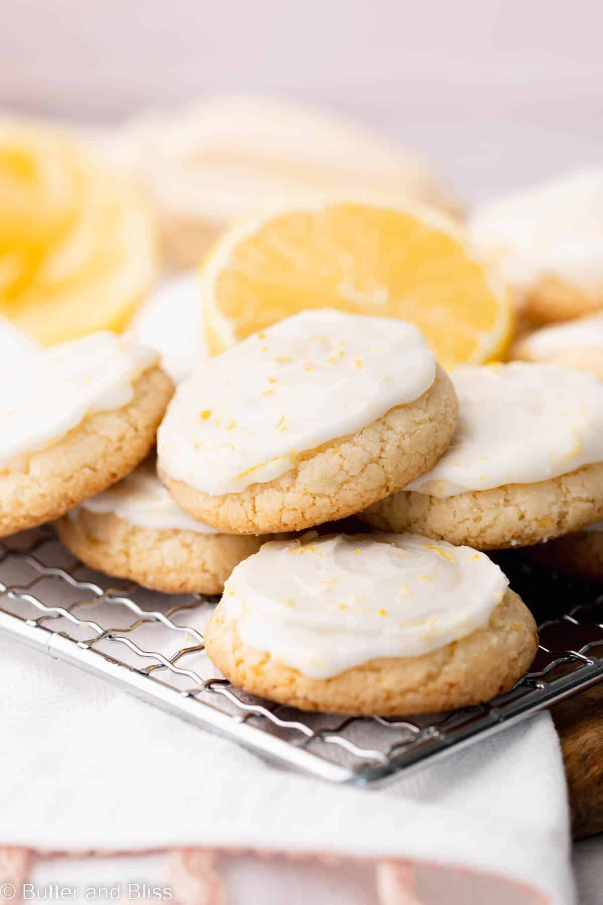 Close up of a glazed gluten free lemon drop shortbread cookie on a wire cooling rack.