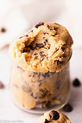 Edible gluten free cookie dough spooned into a small glass cup.